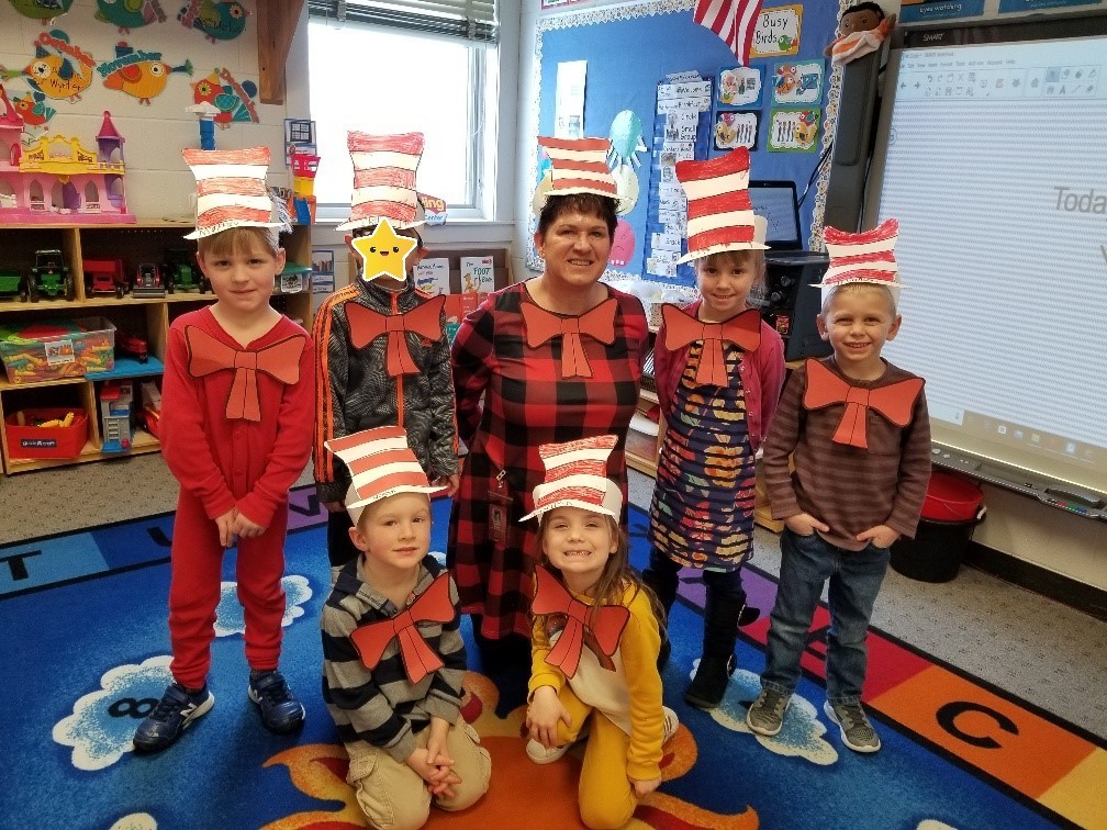 Students dressed up as the cat in the hat pose for a photo